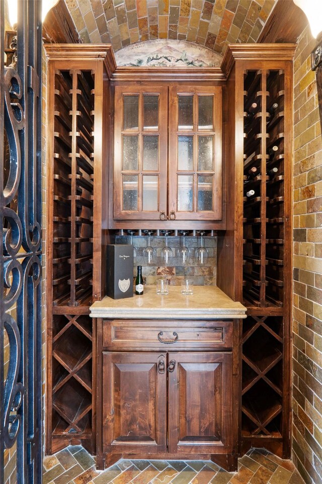 wine cellar featuring lofted ceiling and brick ceiling