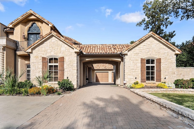 mediterranean / spanish-style house featuring a garage and a carport