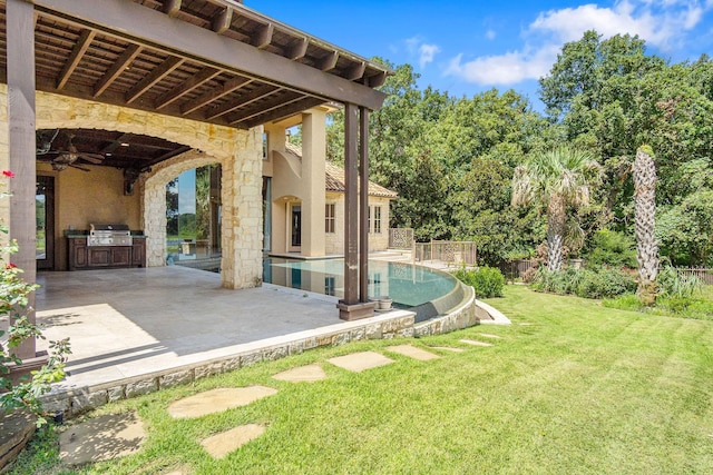 view of yard featuring a patio area and exterior kitchen