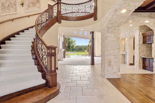 foyer entrance with a high ceiling and light hardwood / wood-style flooring