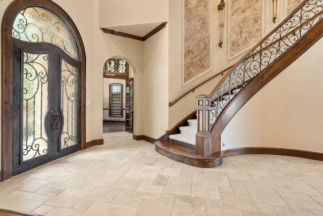 entrance foyer with a high ceiling, french doors, and a wealth of natural light