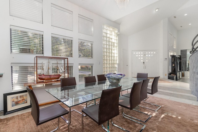 dining room with a towering ceiling and an inviting chandelier