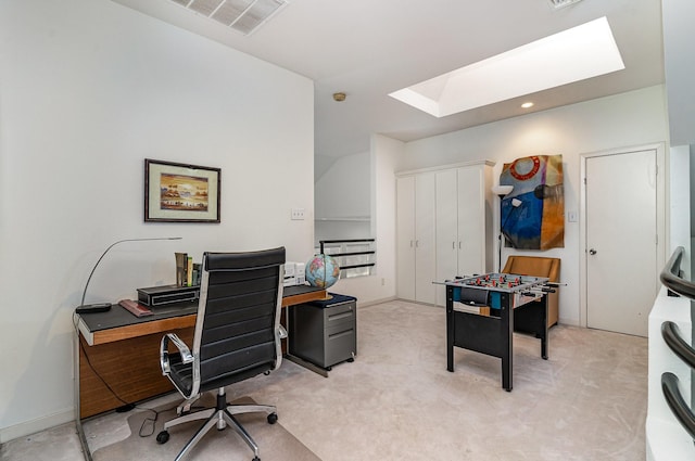 office area with a skylight and light colored carpet