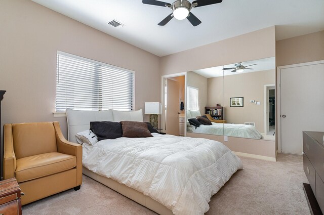 bedroom featuring ceiling fan and light carpet