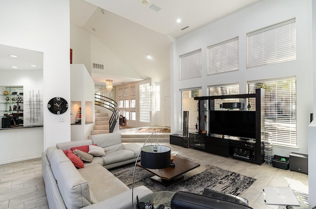 living room featuring high vaulted ceiling