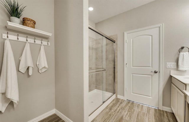 bathroom featuring vanity, a shower with door, and hardwood / wood-style floors