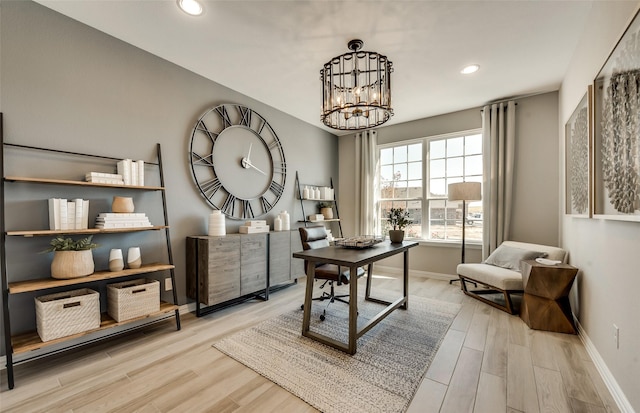 office space with light hardwood / wood-style floors and an inviting chandelier