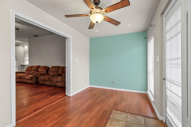 unfurnished room with wood-type flooring and ceiling fan