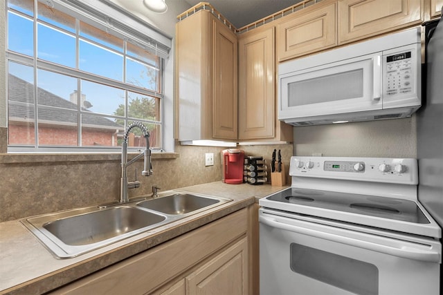 kitchen featuring sink, light brown cabinetry, backsplash, and white appliances