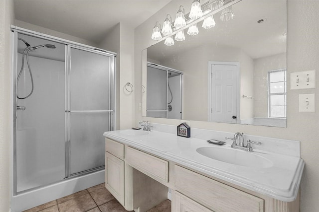 bathroom featuring tile patterned flooring, vanity, and a shower with shower door