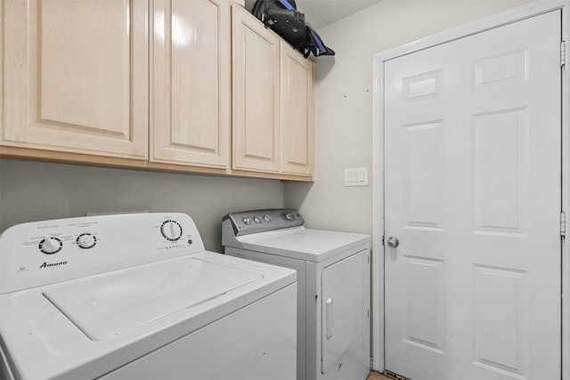 laundry room with cabinets and separate washer and dryer