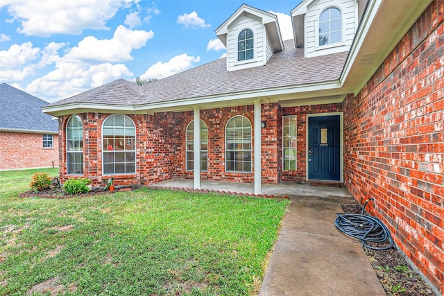 view of front facade with a patio and a front lawn