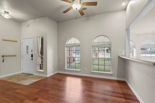 foyer entrance with wood-type flooring and ceiling fan