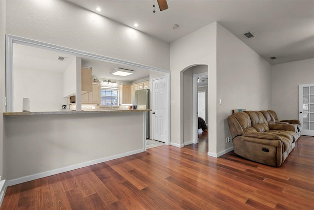 unfurnished living room with dark hardwood / wood-style flooring and ceiling fan