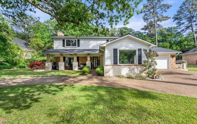 view of front of property with a porch, a garage, and a front lawn