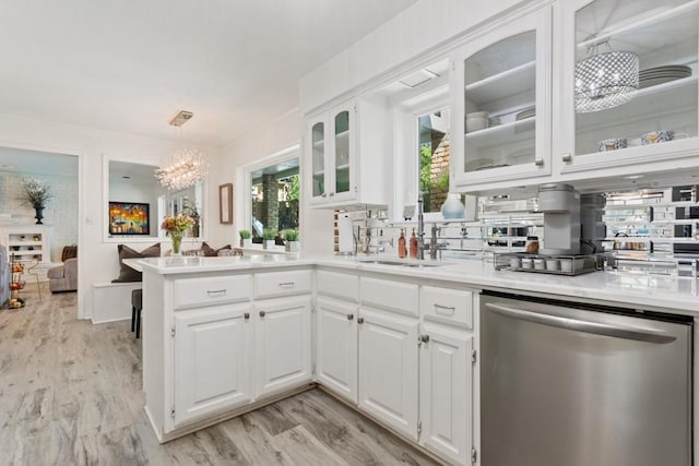 kitchen with dishwasher, decorative light fixtures, white cabinets, and an inviting chandelier