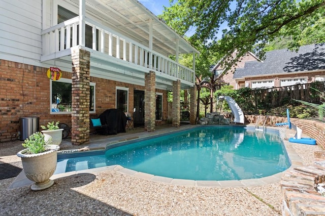 view of pool featuring a grill, a patio area, and a water slide