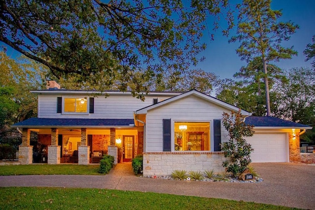 view of front of house featuring a porch and a garage