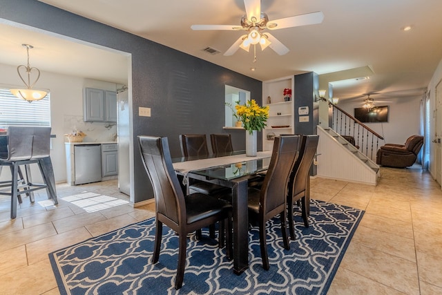 tiled dining area with ceiling fan