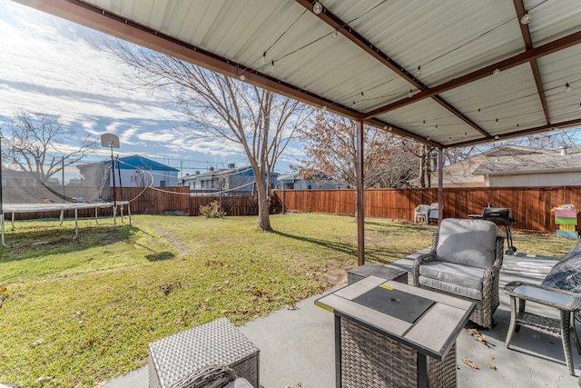 view of yard featuring a patio and a trampoline