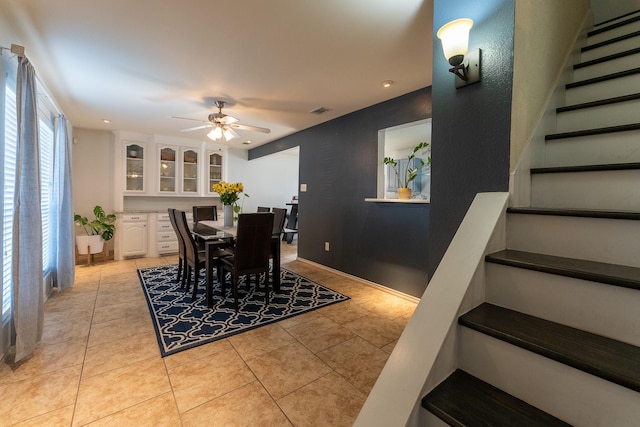 dining space with ceiling fan and light tile patterned flooring