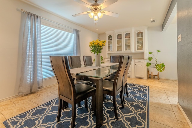 dining space featuring ceiling fan and light tile patterned floors