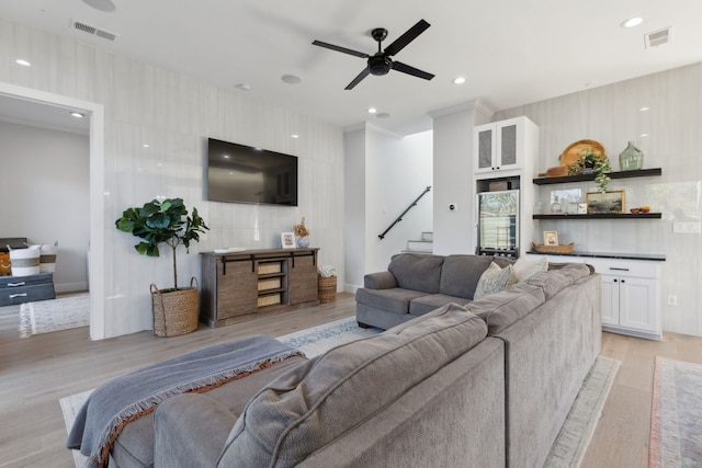 living room featuring light wood-type flooring and ceiling fan