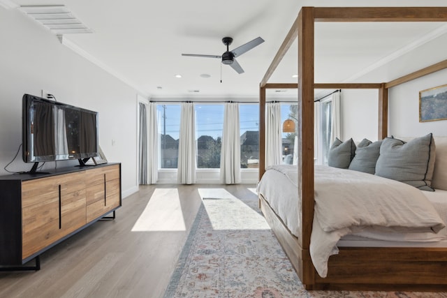 bedroom with ceiling fan, light hardwood / wood-style floors, and crown molding