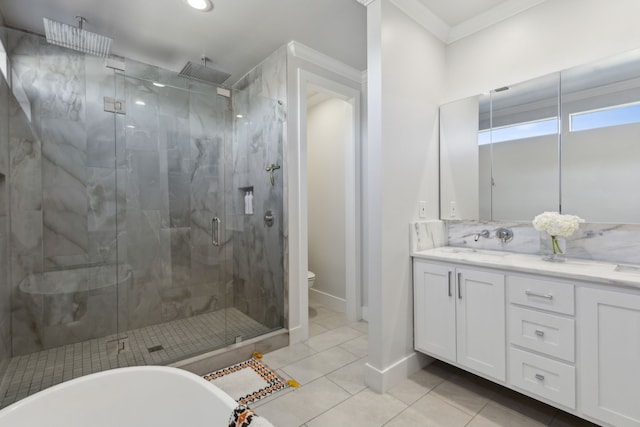 full bathroom with tile patterned floors, crown molding, toilet, vanity, and independent shower and bath