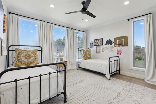 bedroom with wood-type flooring, ceiling fan, and ornamental molding