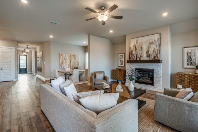 living room featuring a fireplace, visible vents, wood finished floors, and recessed lighting