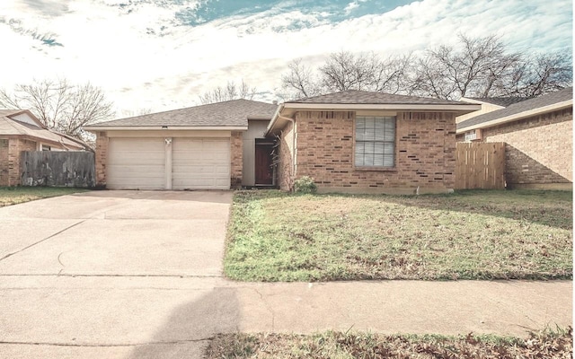 ranch-style home featuring a garage and a front lawn