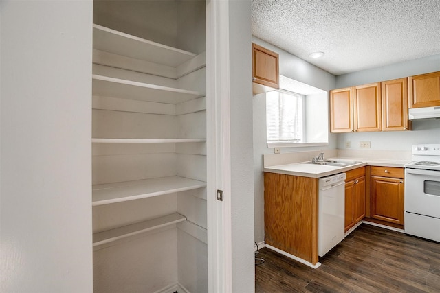 kitchen featuring a textured ceiling, white appliances, sink, and dark wood-type flooring