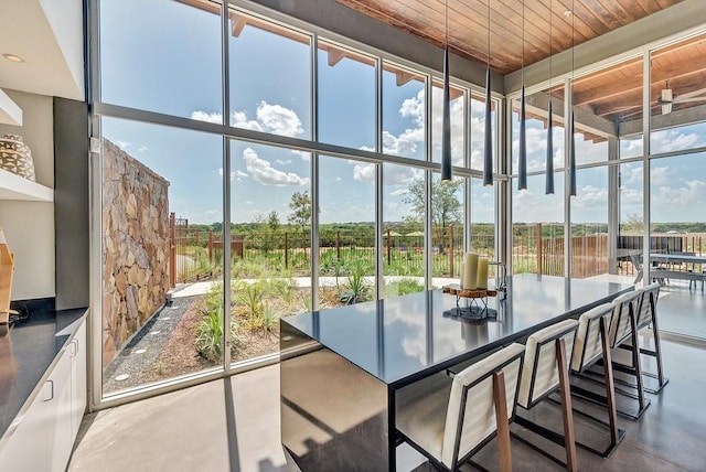 sunroom / solarium with a healthy amount of sunlight and wood ceiling