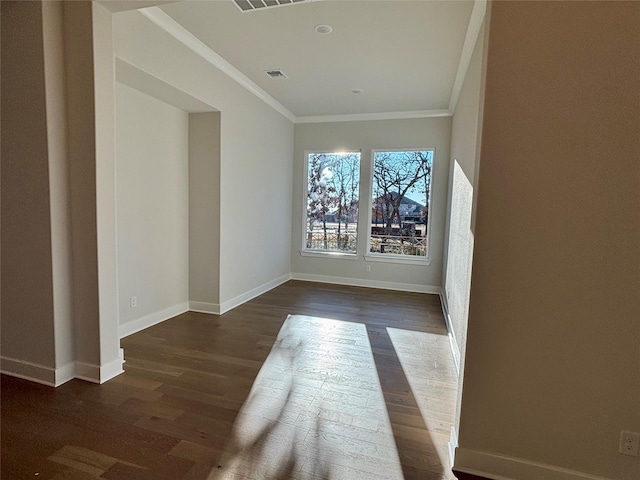 spare room with dark hardwood / wood-style floors and ornamental molding