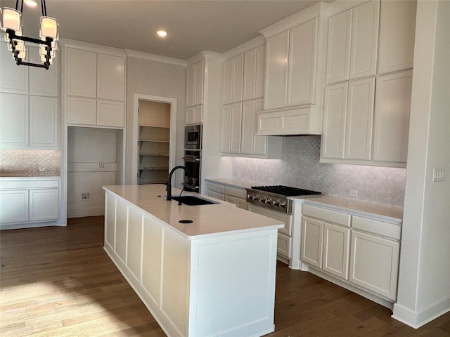 kitchen featuring sink, hanging light fixtures, an island with sink, white cabinets, and appliances with stainless steel finishes