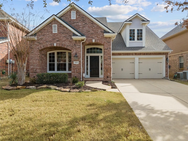 view of property with a front yard, a garage, and central AC