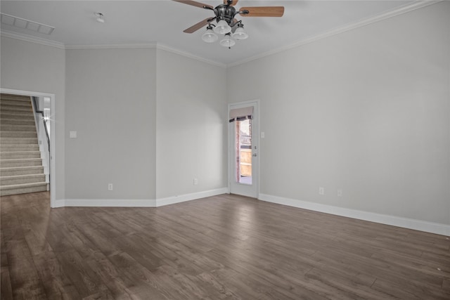 spare room featuring ornamental molding, dark wood-type flooring, and ceiling fan