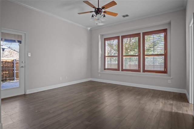 unfurnished room with ornamental molding, a wealth of natural light, and dark hardwood / wood-style floors