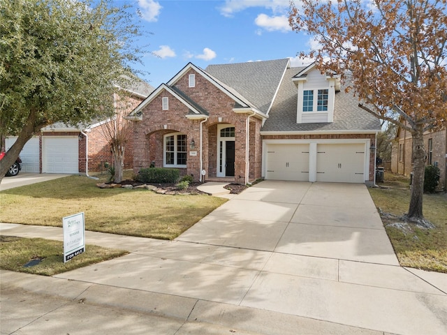 view of front of property with a front yard and a garage