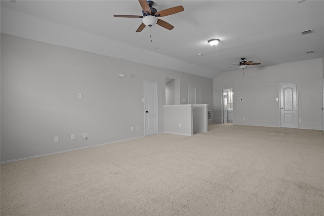 spare room featuring ceiling fan, light carpet, and lofted ceiling