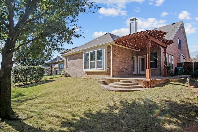 back of property with a yard and a pergola