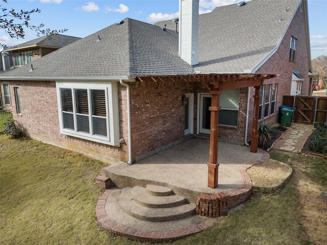 rear view of house featuring a yard and a patio