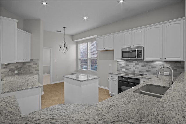 kitchen featuring black appliances, white cabinetry, and sink