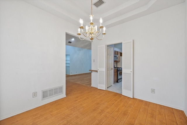 interior space featuring light wood-type flooring and a chandelier