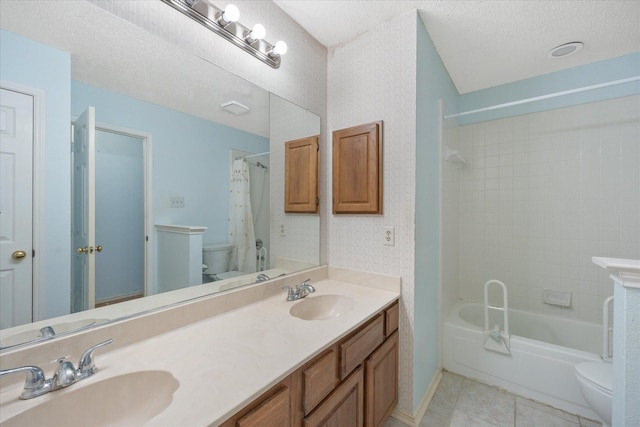 full bathroom with vanity, a textured ceiling, toilet, and shower / bath combo with shower curtain