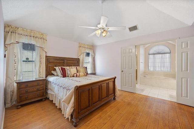 bedroom featuring light hardwood / wood-style flooring, ceiling fan, and lofted ceiling