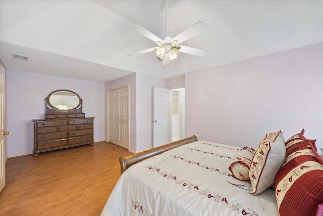 bedroom with hardwood / wood-style floors, ceiling fan, and a closet