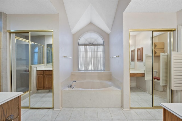 full bathroom featuring a textured ceiling, vanity, separate shower and tub, toilet, and lofted ceiling