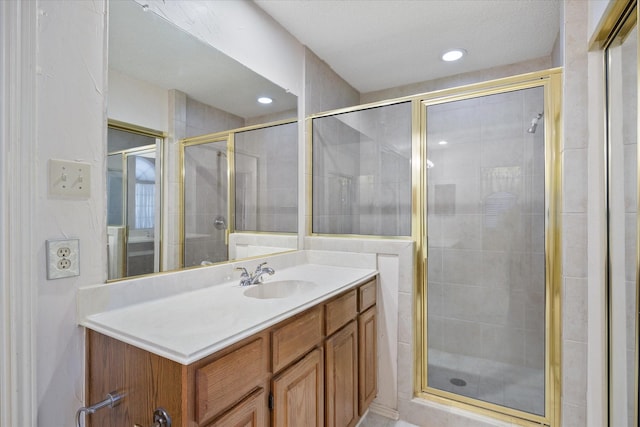 bathroom with vanity and a shower with door